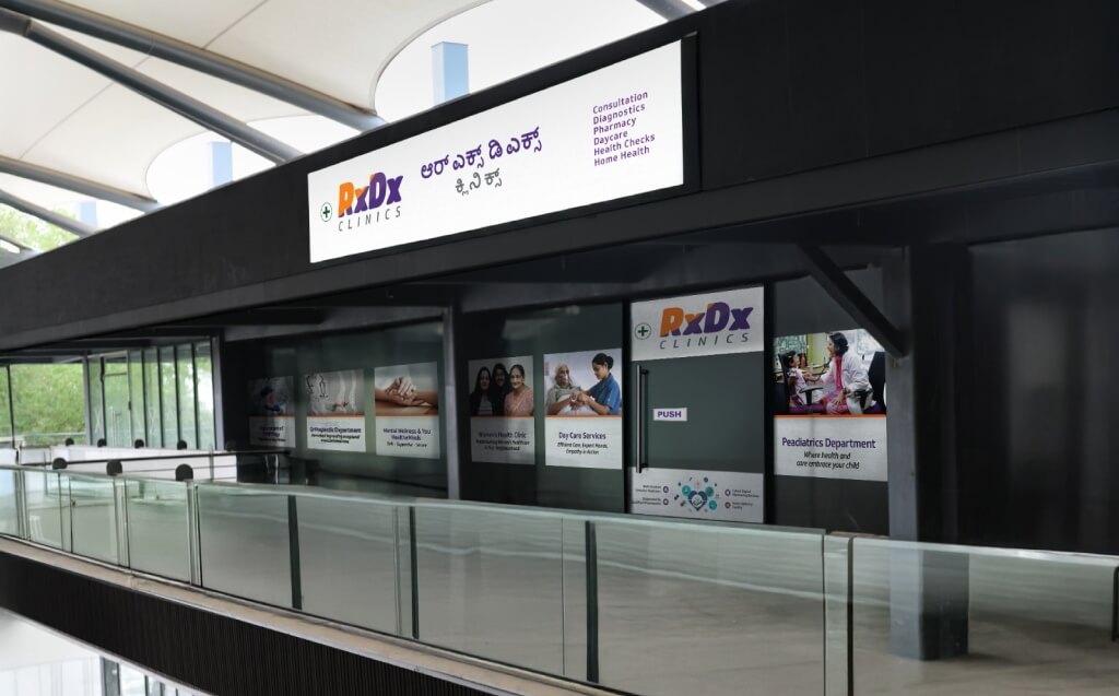 Nighttime exterior view of the RxDx Clinics branch in Budigere.