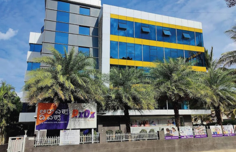 Modern glass exterior of the RxDx Clinics building in Jakkur, Bangalore.